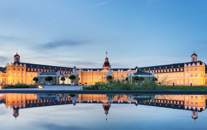 Karlsruhe castle reflected in water in summer evening