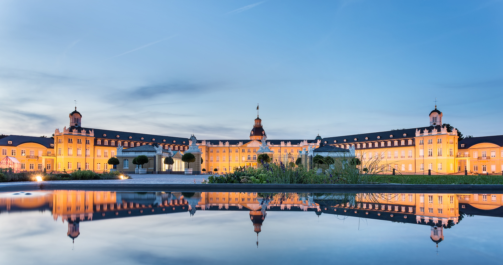 Karlsruhe castle reflected in water in summer evening