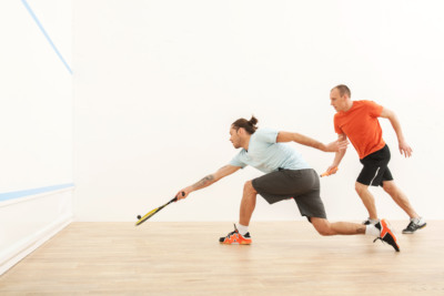 Two men playing match of squash. Squash players in action on squash court Zwei Männer spielen Squash.